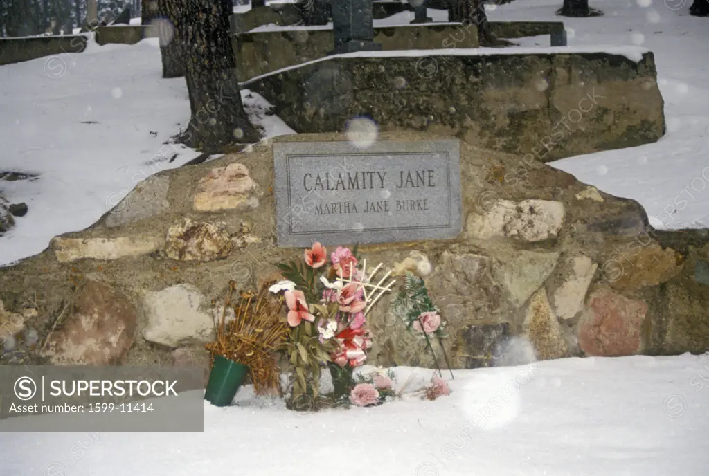 Grave site of Calamity Jane, infamous outlaw in Mount Moriah Cemetery, Deadwood, SD in winter snow