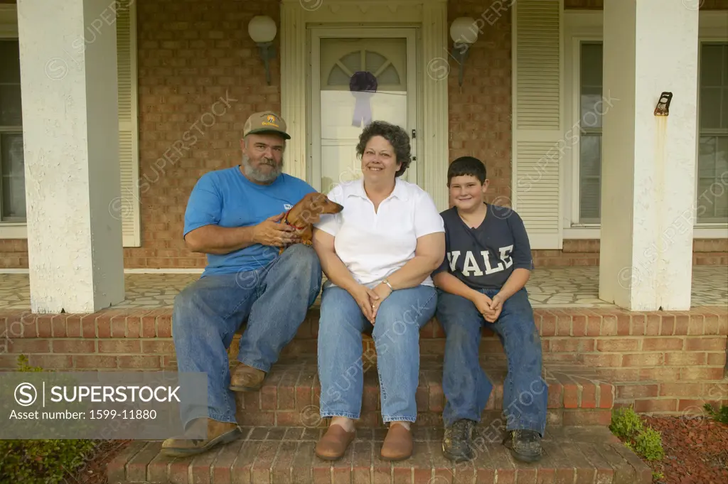 Mom, Pop and boy-family sitting on front porch of house in Central GA on Highway 22