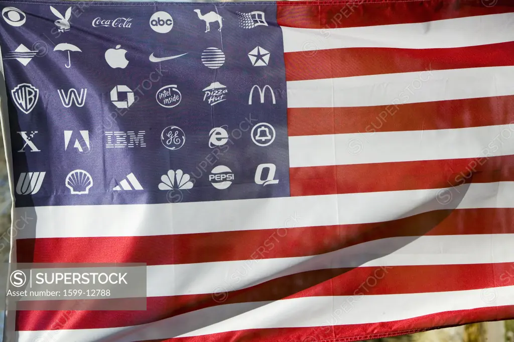 Corporate logos in place of stars on the American flag symbolize allegiance to and dominance of Corporate America.