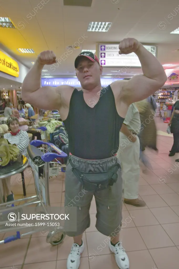 Afrikaner bodybuilder with big muscles in airport of Durban, South Africa