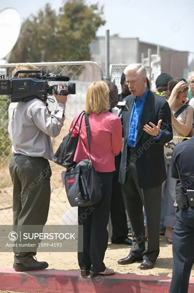 Former Governor Gray Davis being interviewed by newscaster and cameraman, CSU- Dominguez Hills, Los  Angeles, CA