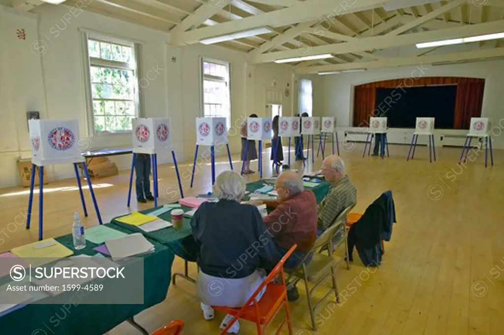 Election volunteers and voting booths in a polling place, CA