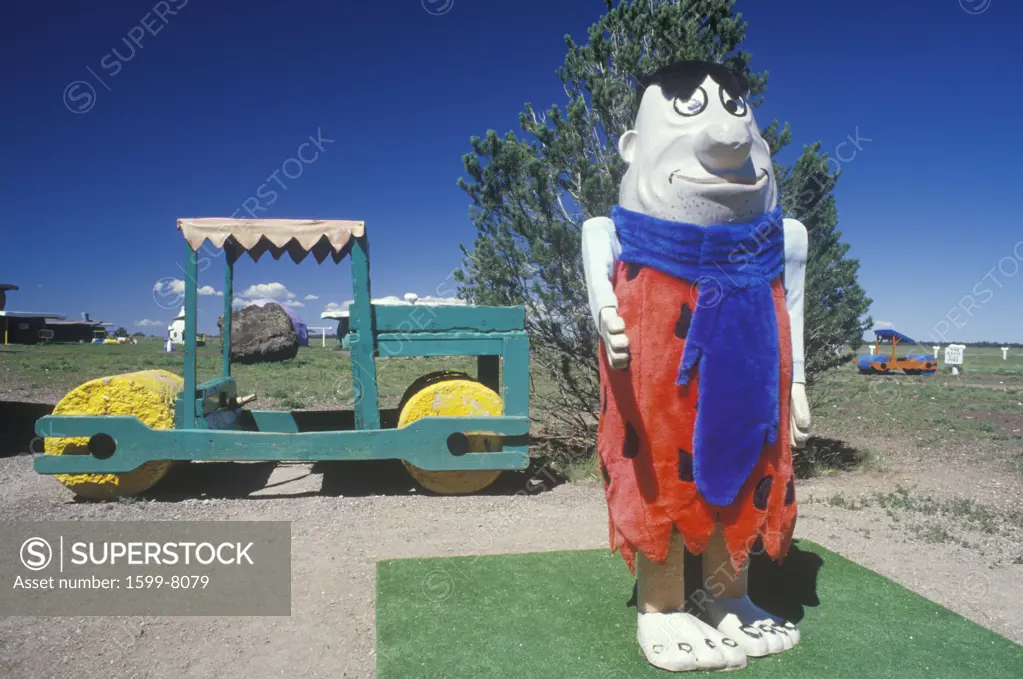 A statue of Fred Flintstone and the Flintstone vehicle at Fred Flintstone Land in Arizona, near the Grand Canyon