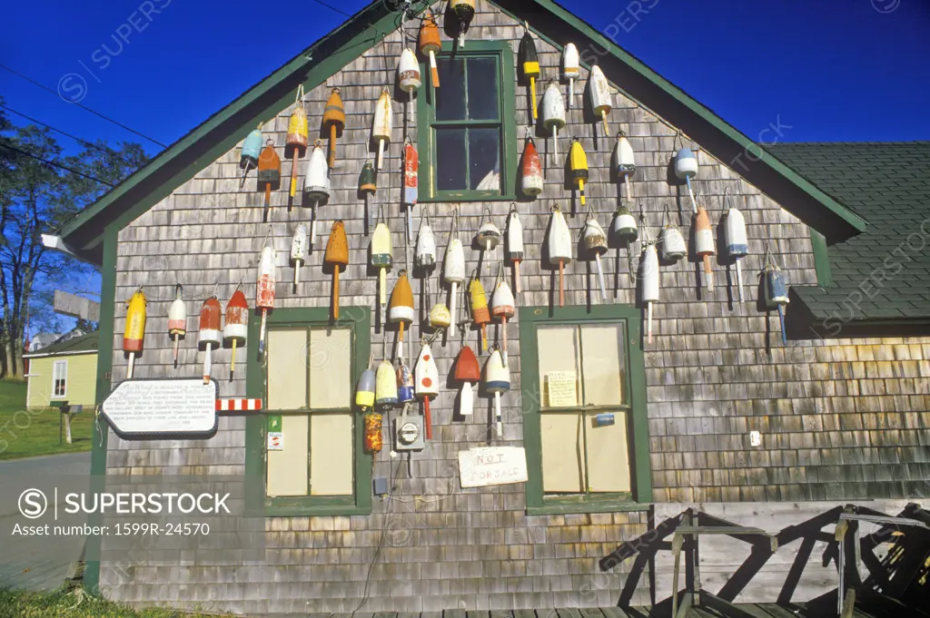 Lobster buoys on side of building in Muscongus Bay in New Harbor ME