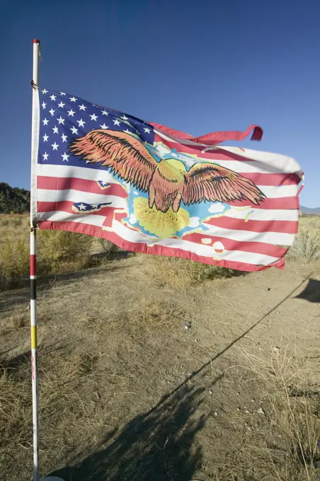 Native American Indian flag blows in wind on Chumash Indian land on highway 33, near Cuyama California