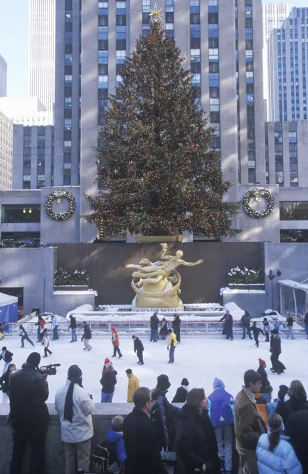 Rockefeller Square with snowy ice skating rink and Christmas tree in mid-town Manhattan, NY