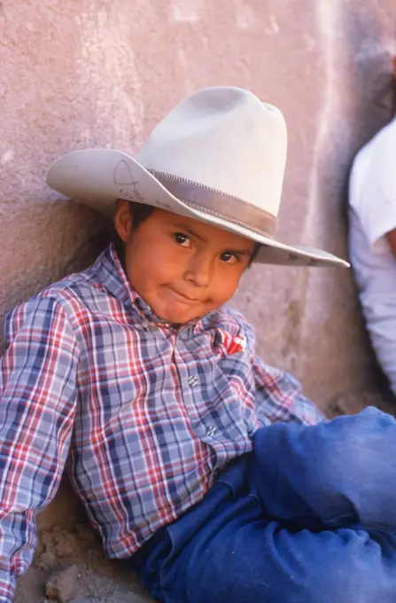 Young Native American cowboy lying on ground, Gallup, New Mexico