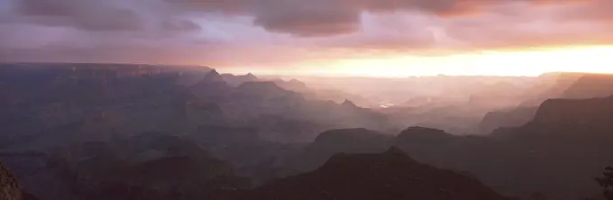 This is the south rim of the Grand Canyon known as Grand View Point.  Also in view is the Colorado River at sunrise.