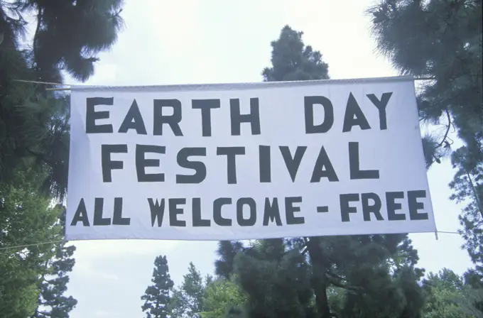 A hanging sign welcoming people to the Earth Day Festival