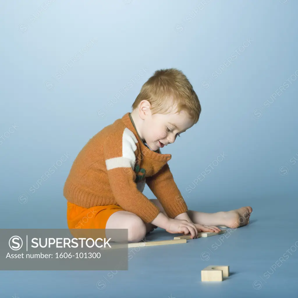 Little boy playing with construction game