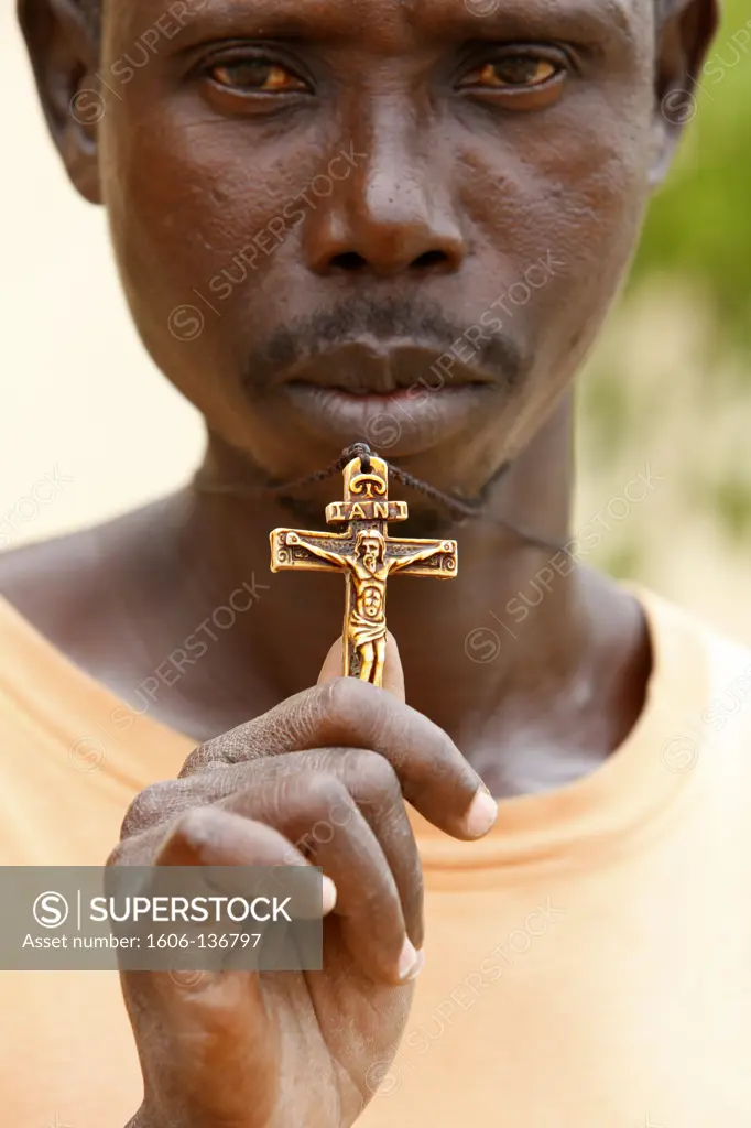 Togo, Lomé. Catholic man and his crucifix. Togo.