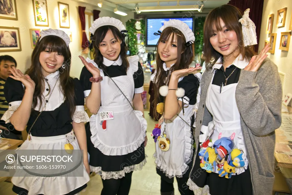 Cute young Japanese girls working at Popopure Maid Cafe wear French maid's uniforms and perpetual smiles in Akihabara located near the Kanda River in the Chiyoda-ku District, Tokyo, Japan