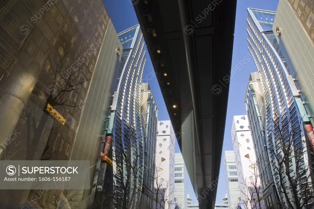 Sleek new architecture, featuring the wavy angles of the DeBeers Ginza Building, highlights the fashion boutiques on Matsuya Dori Street in the heart of the Ginza District for upscale shopping in Tokyo, Japan.