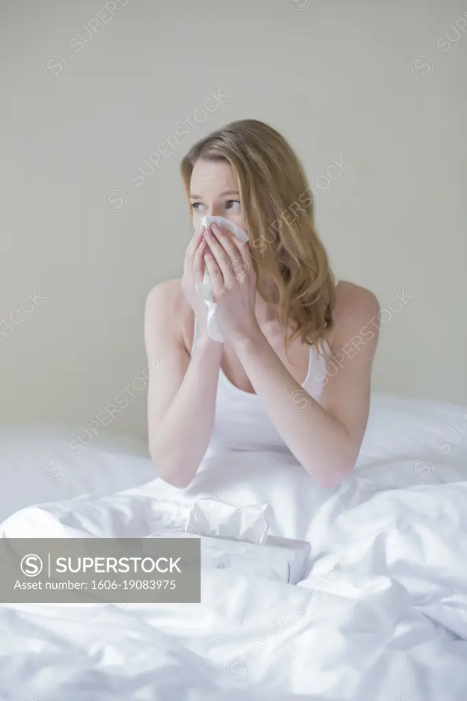 Woman sick with handkerschiefs in bed