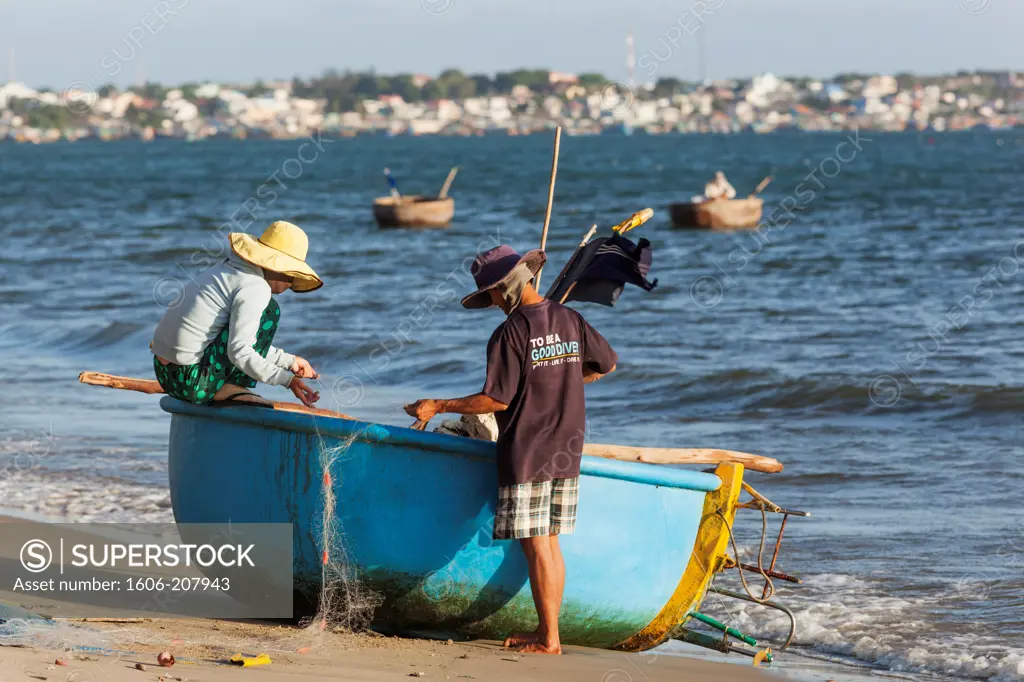 Vietnam,Mui Ne,Mui Ne Beach,Fishermen with Coracle Fishing Boat