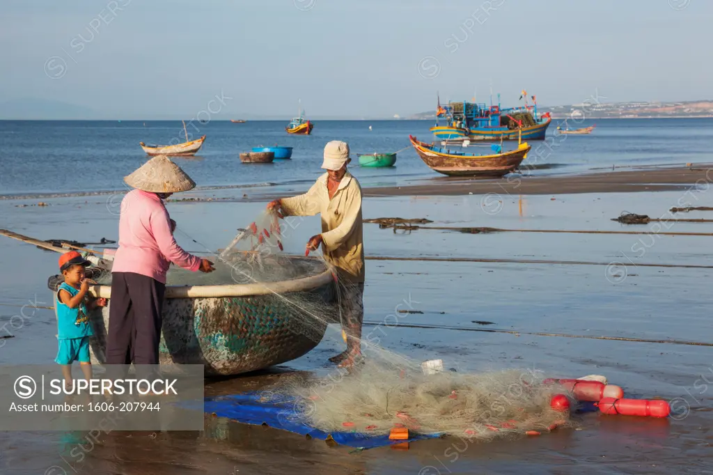 Vietnam,Mui Ne,Mui Ne Beach,Fishermen with Coracle Fishing Boat