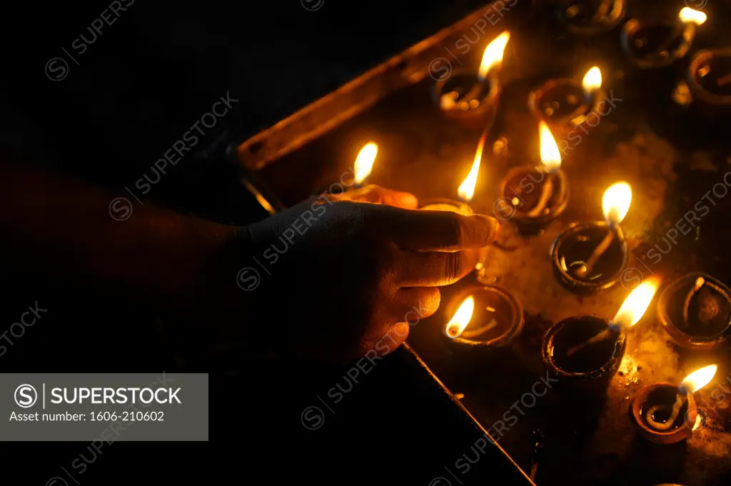 close-up of hand holding a candle Inside of the Meenakshi hindu temple in Madurai,Tamil Nadu,South India,Asia