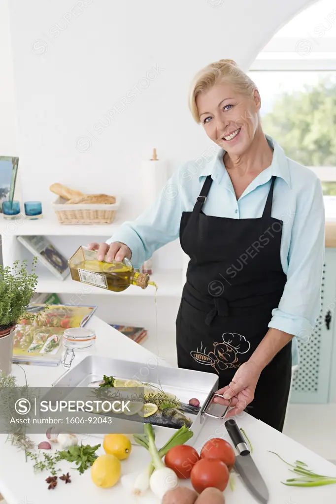 Mature woman cooking fish