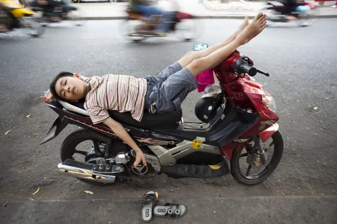 Vietnam,Vietnam,Ho Chi Minh City,Boy Sleeping on Motorbike