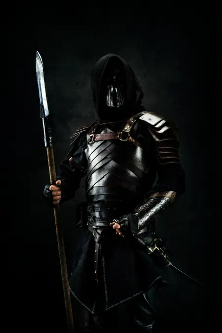 Sarmatian knight in studio on black background.