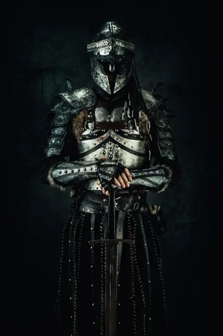 Sarmatian knight in studio on black background.