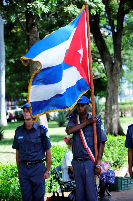 Policeman Holding A Flag In Havana, Cuba