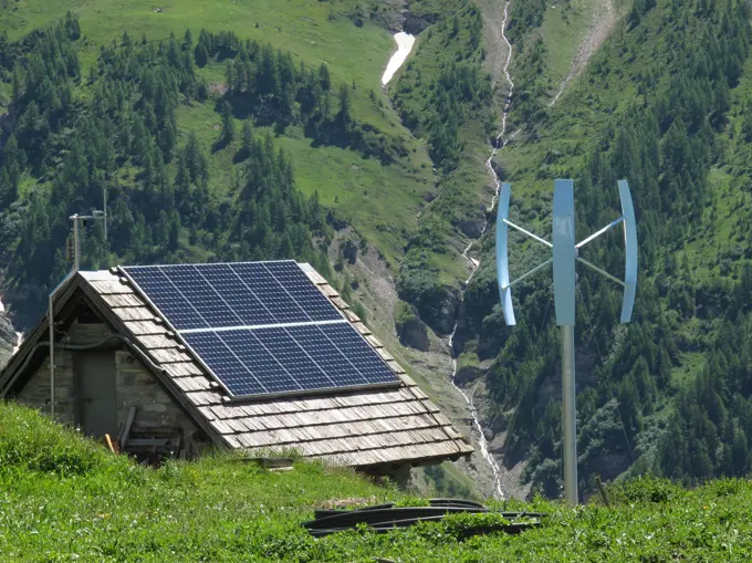 Italia,Aoste valley, Ferret valley,Courmayeur, tour du mont blanc,a small building at Bertone mountain hut is covered by solar panels and has a wind turbine