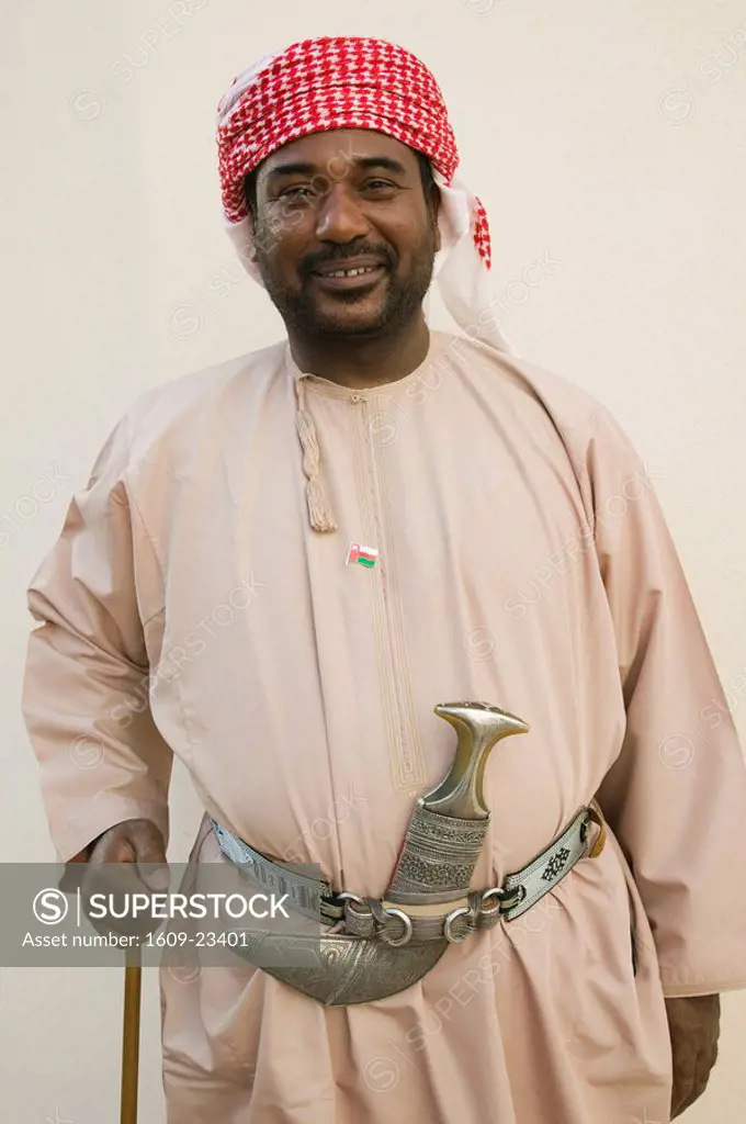 Oman, Muscat, Bayt Az-Zubair Museum- museum guard with traditional Omani Khandjar Dagger