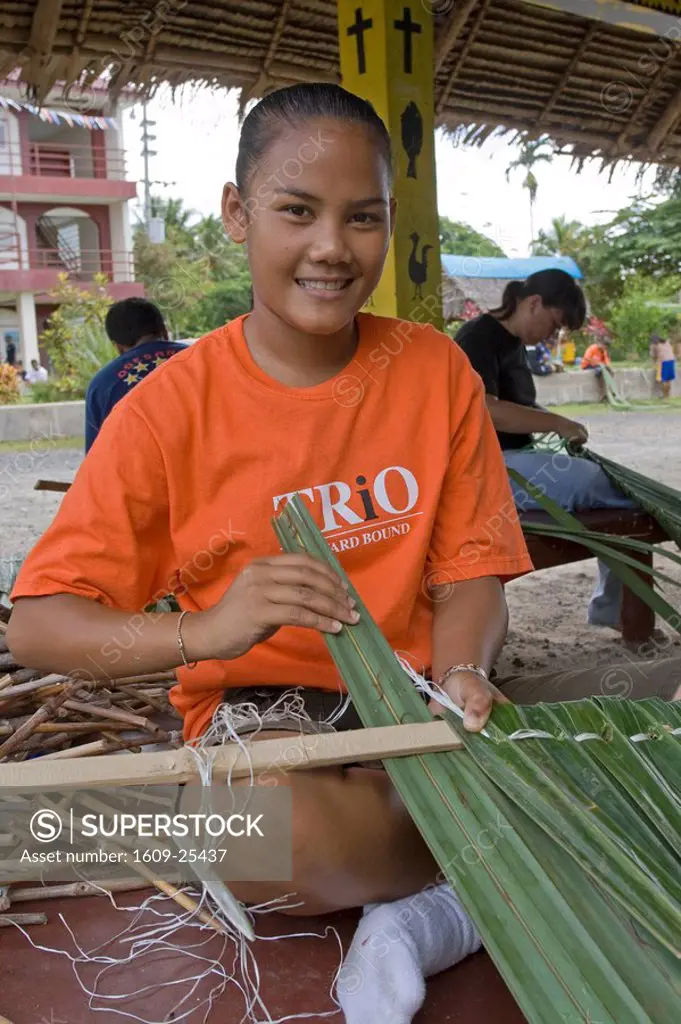 Young Palauan girl weaving a roof with Pandanus leaves, Koror High School, Palau, Micronesia