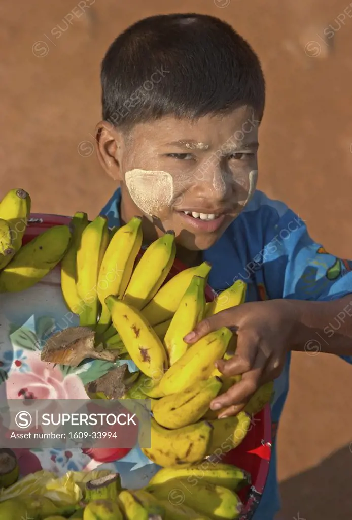 Burmese boy carrying bananas, Kyaikhtiyo, Myanmar Burma