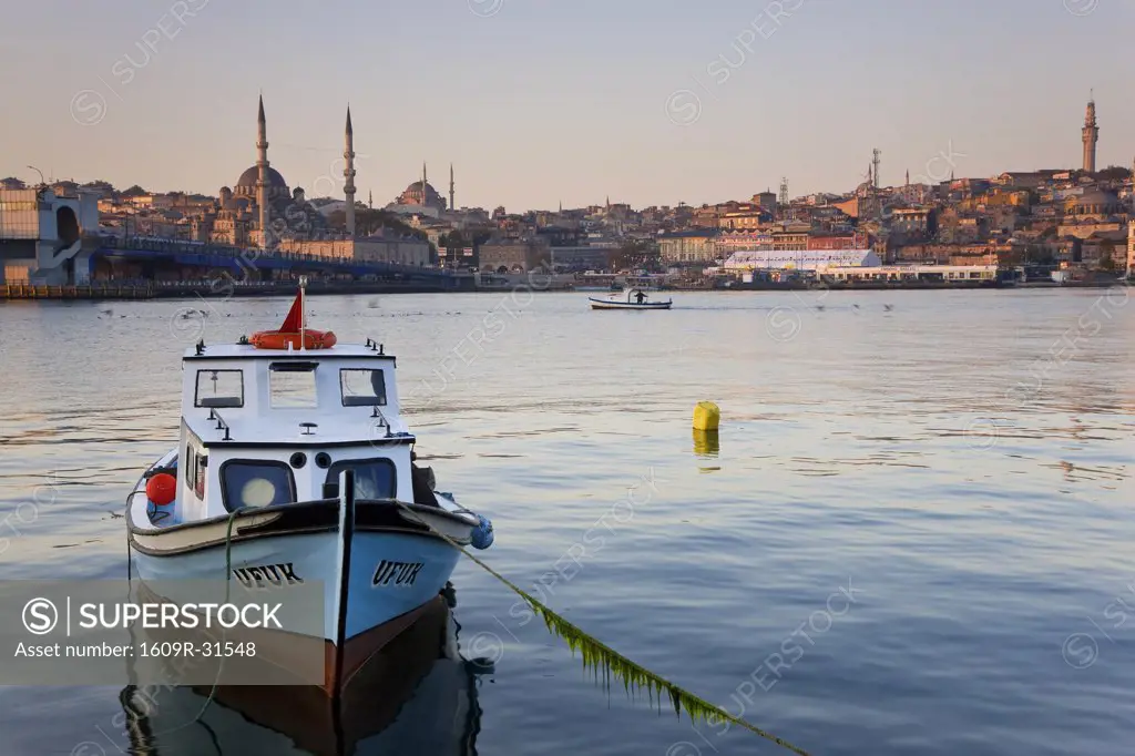 Boat on The Bosphorus, mosque on skyline, Istanbul, Turkey