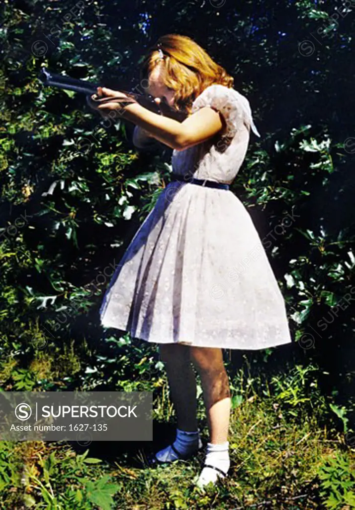 Side profile of a girl shooting with a rifle