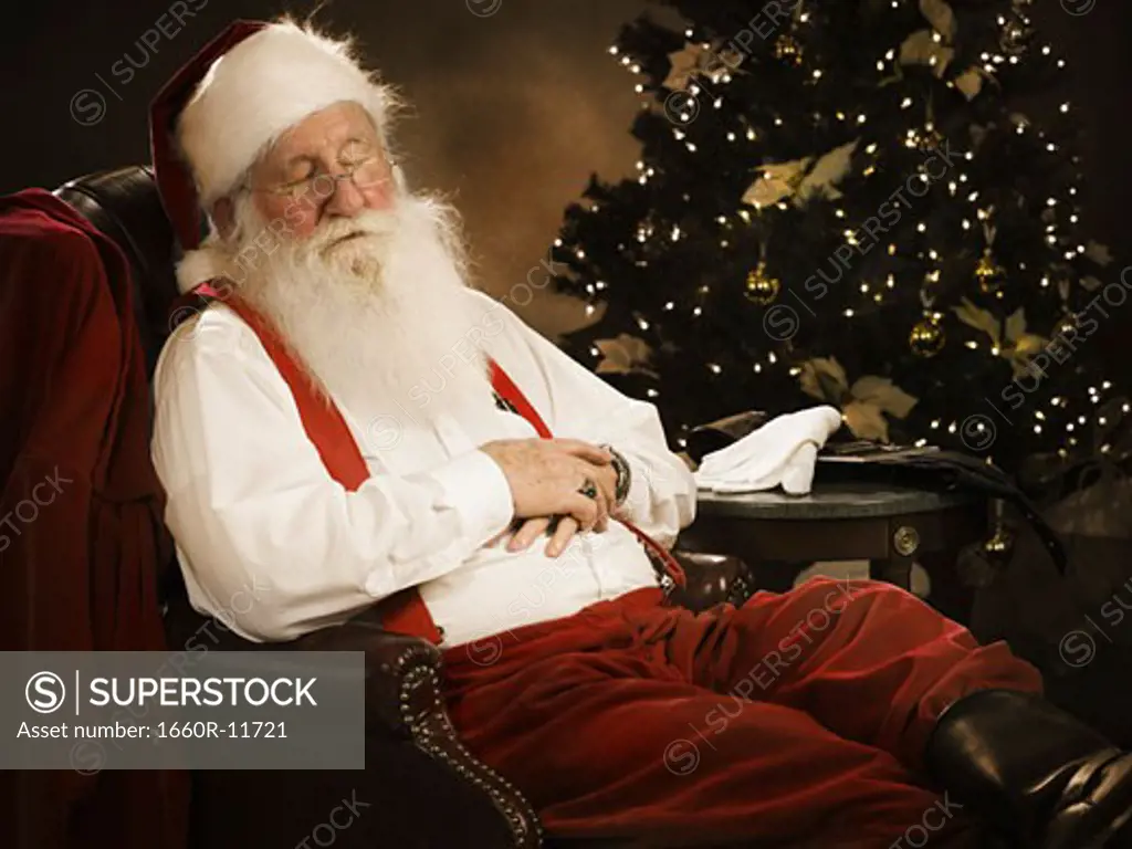 Close-up of Santa Claus sleeping on a chair