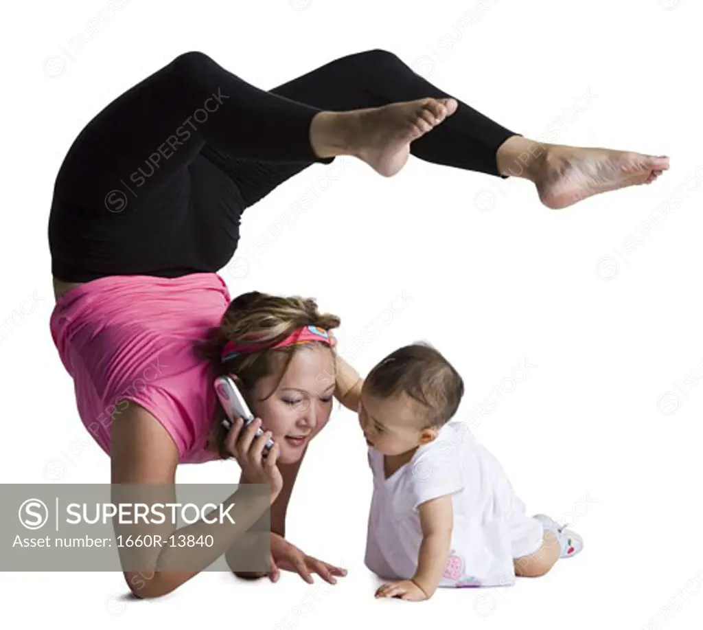 Contortionist mother with baby daughter