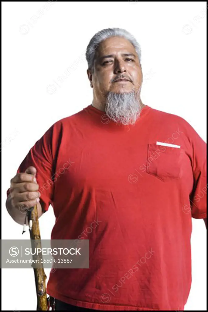 Older heavyset man with a long gray beard holding a cane