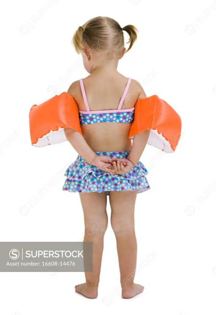 Young girl with personal flotation devices around arms