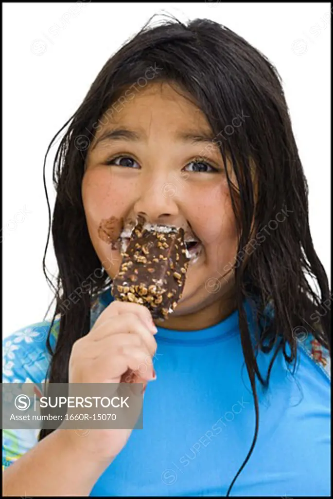 Overweight young girl eating ice cream bar