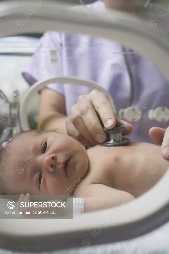 Doctor examining a newborn baby boy