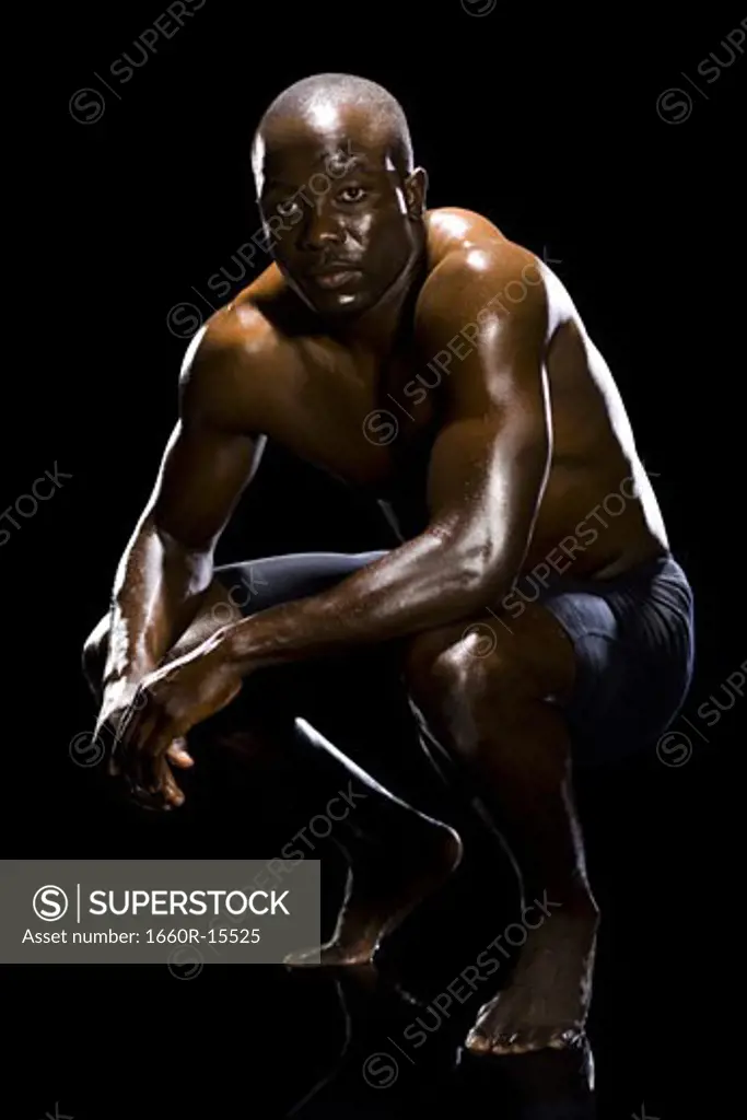 Muscular athlete in dark room