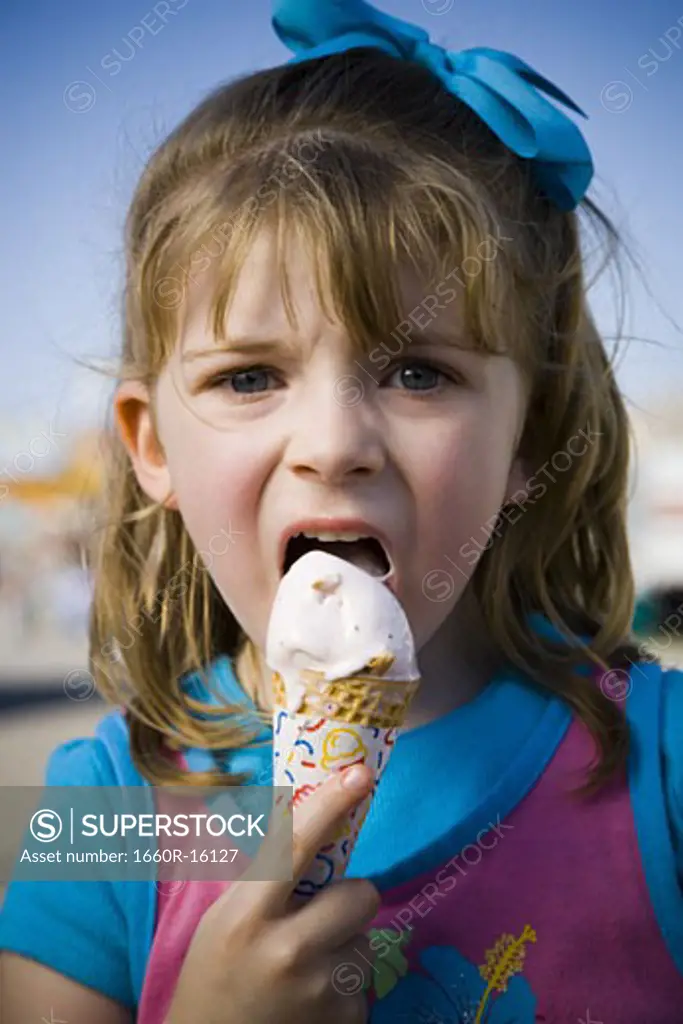 Young girl eating ice cream cone