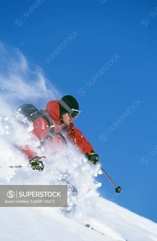 Downhill skier skiing on mountain