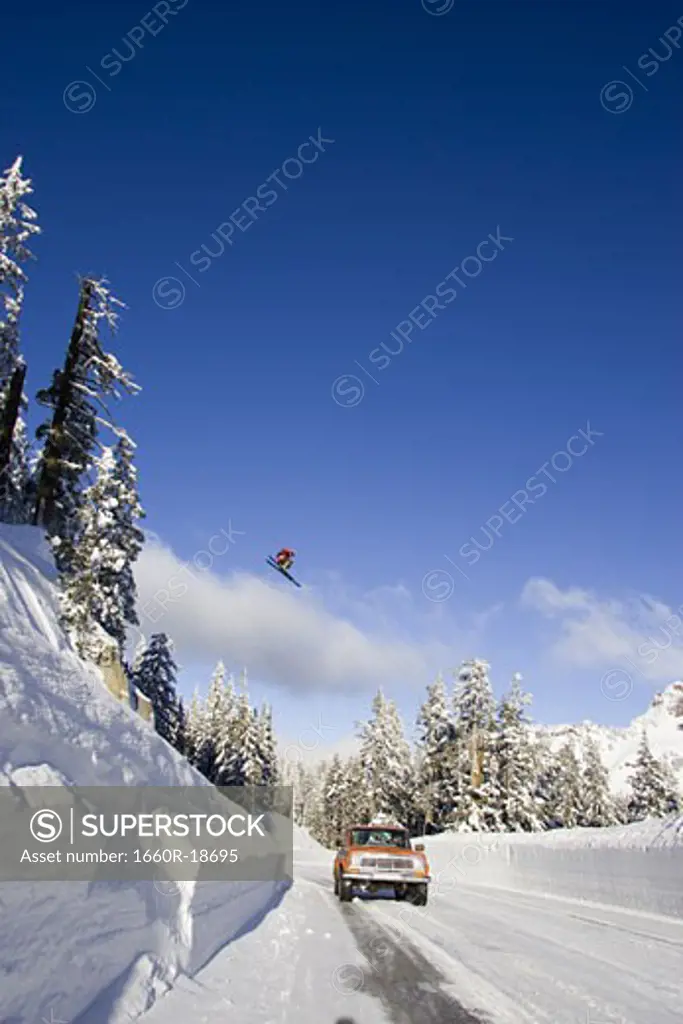 Downhill ski jumper in air