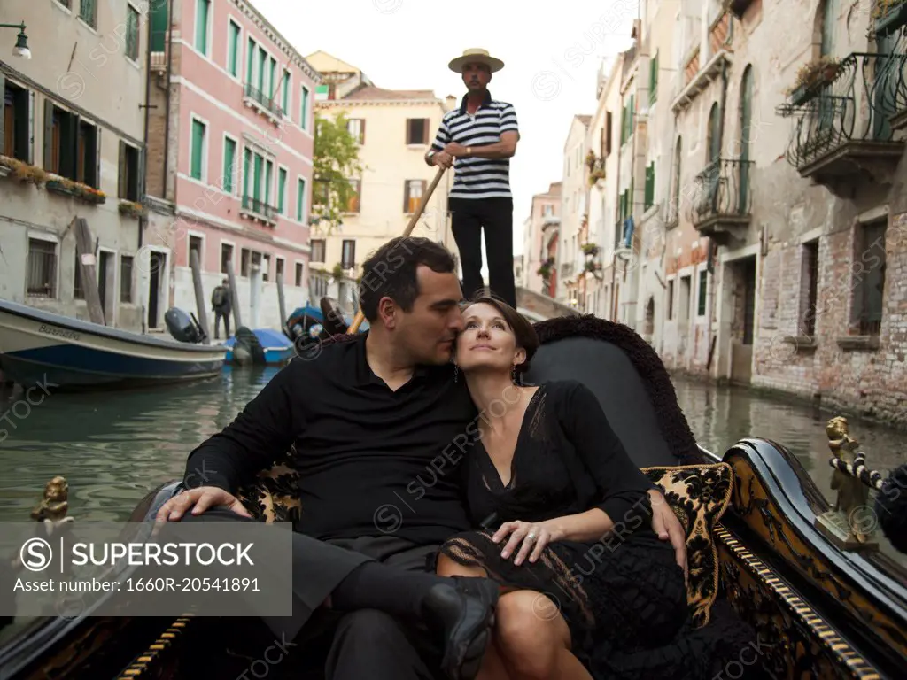 Italy, Venice, Mature couple embracing in gondola