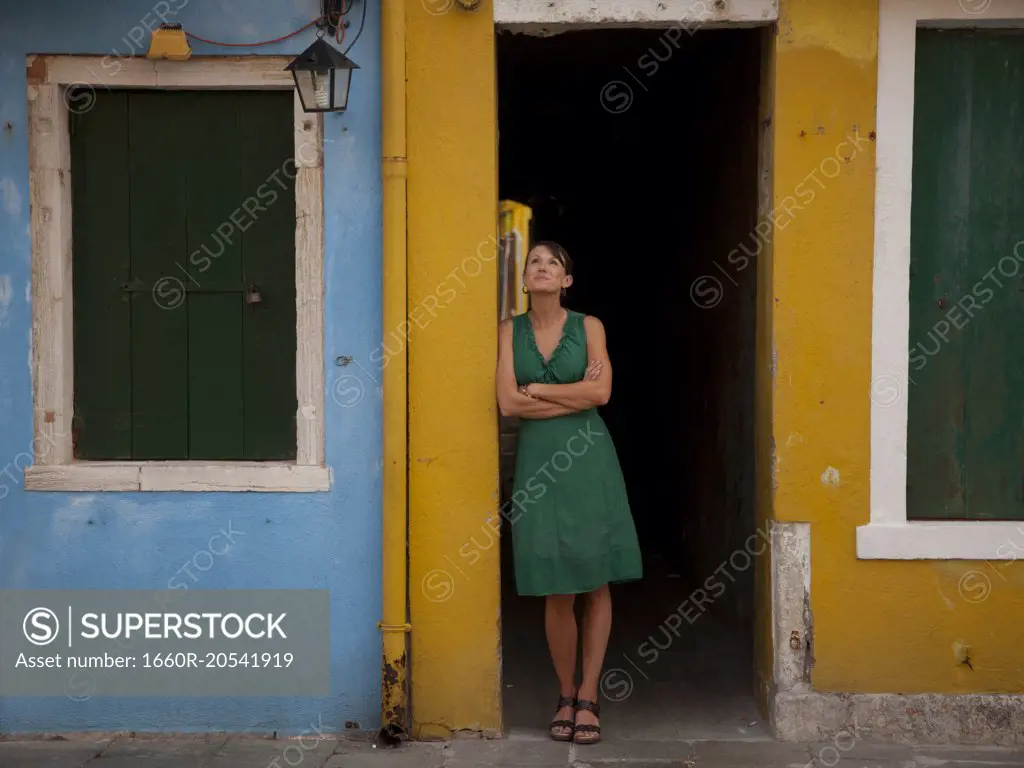 Italy, Venice, Portrait of woman standing in front of old italian house