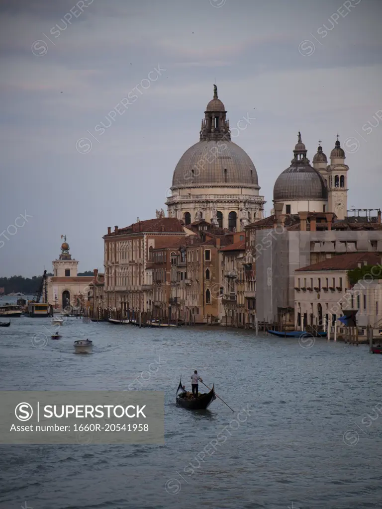 Italy, Venice, Lonely gondolier in gondola on canal