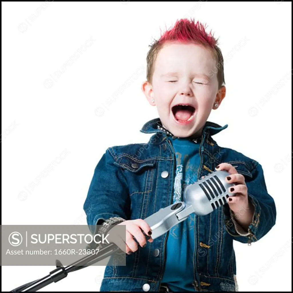 little boy singing into a microphone