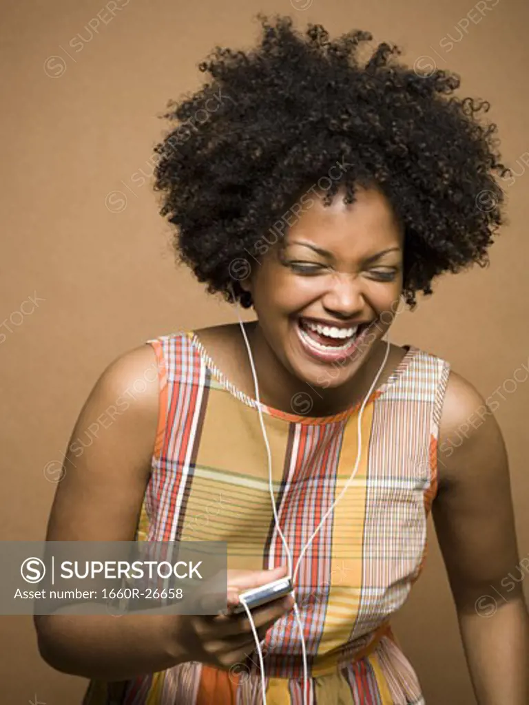 Close-up of a young woman listening an MP3 player