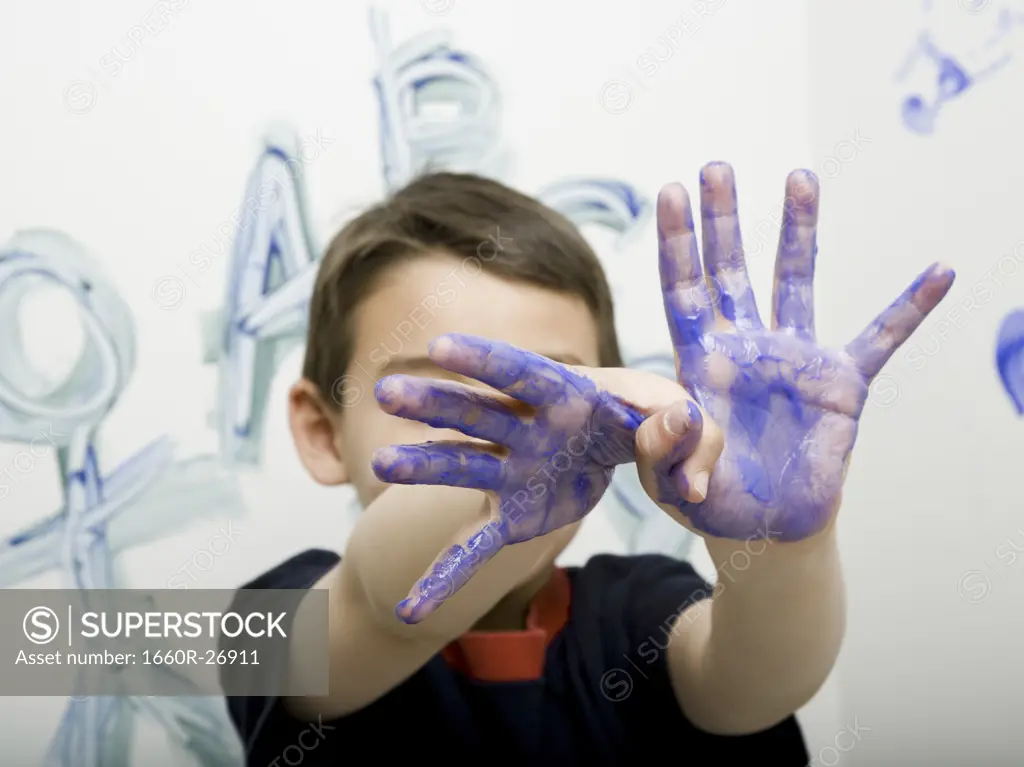 Portrait of a boy showing his painted hand