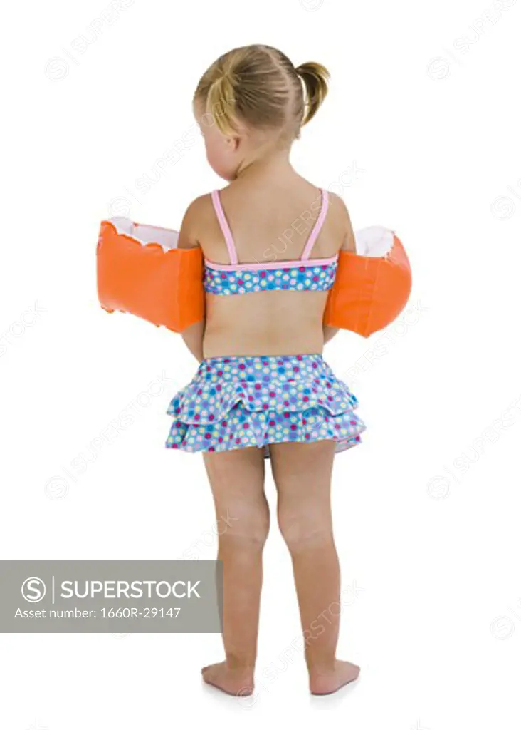 Young girl with personal flotation devices around arms