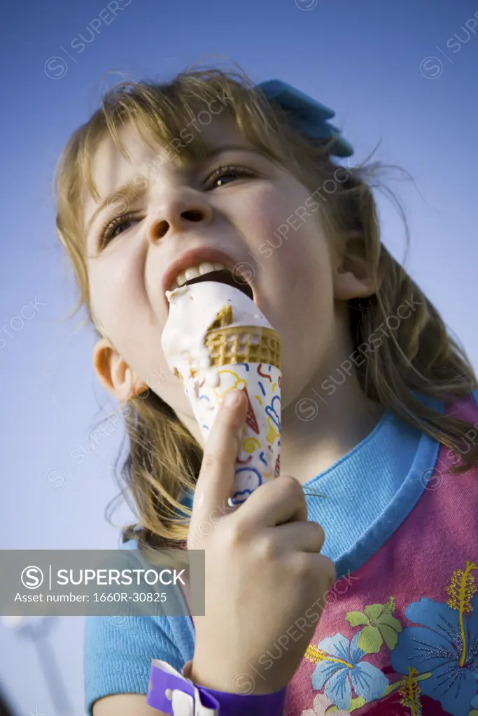 Young girl eating ice cream cone